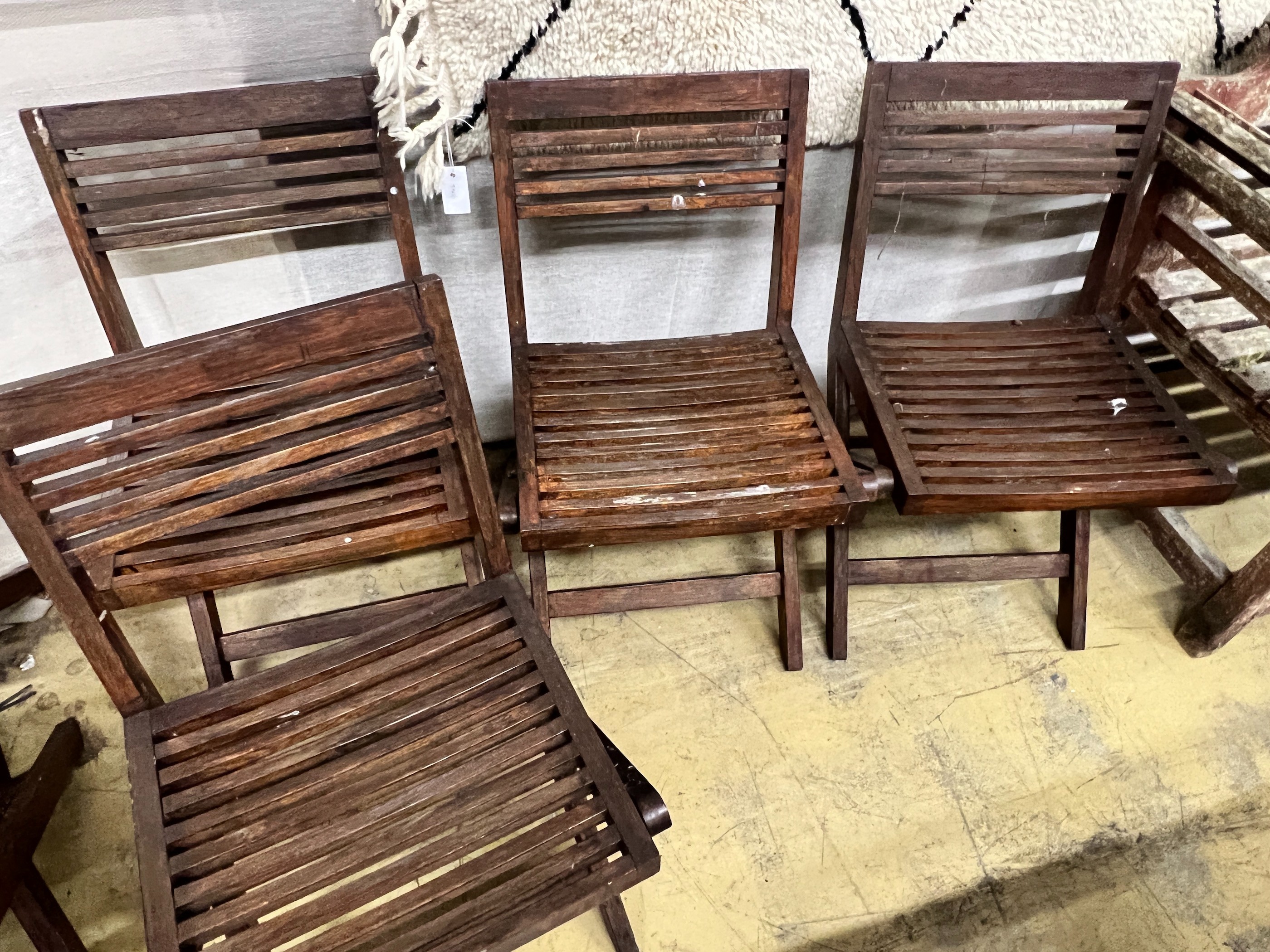 A set of six slatted teak garden chairs